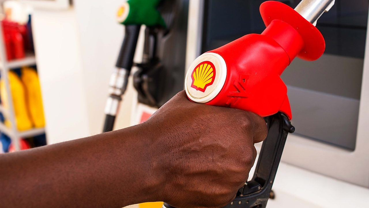 Service attendant holding a fuel nozzle