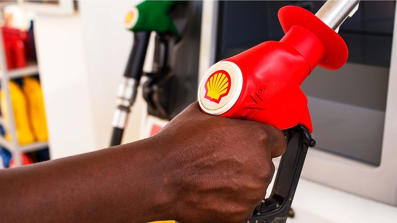 Service attendant holding a fuel nozzle