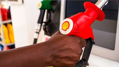 Service attendant holding a fuel nozzle