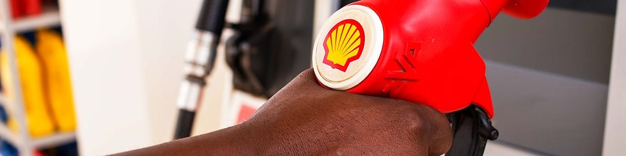 Service attendant holding a fuel nozzle