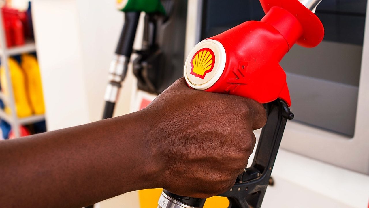 Service attendant holding a fuel nozzle